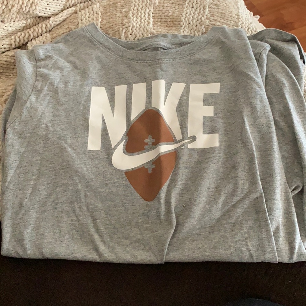 Grey Nike shirt.